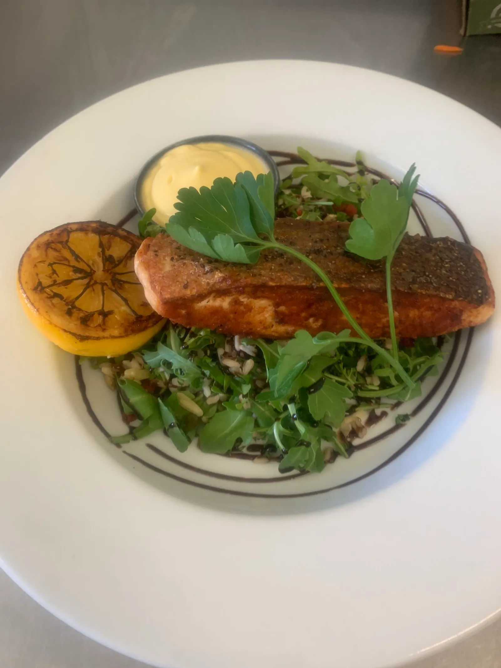 Pan-seared salmon fillet with rice salad and charred lemon