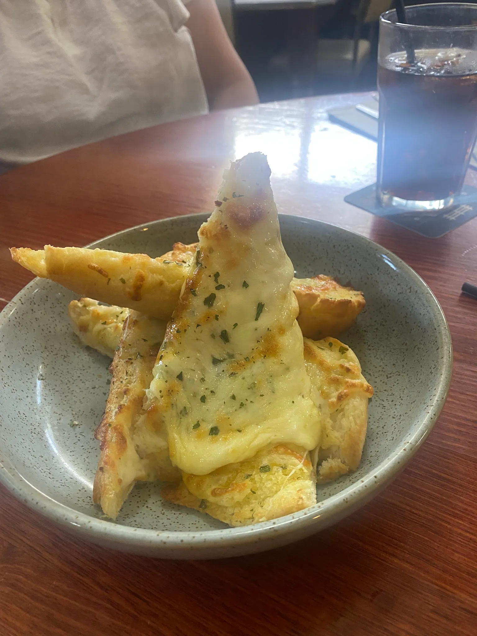 Cheesy garlic bread wedges in a bowl