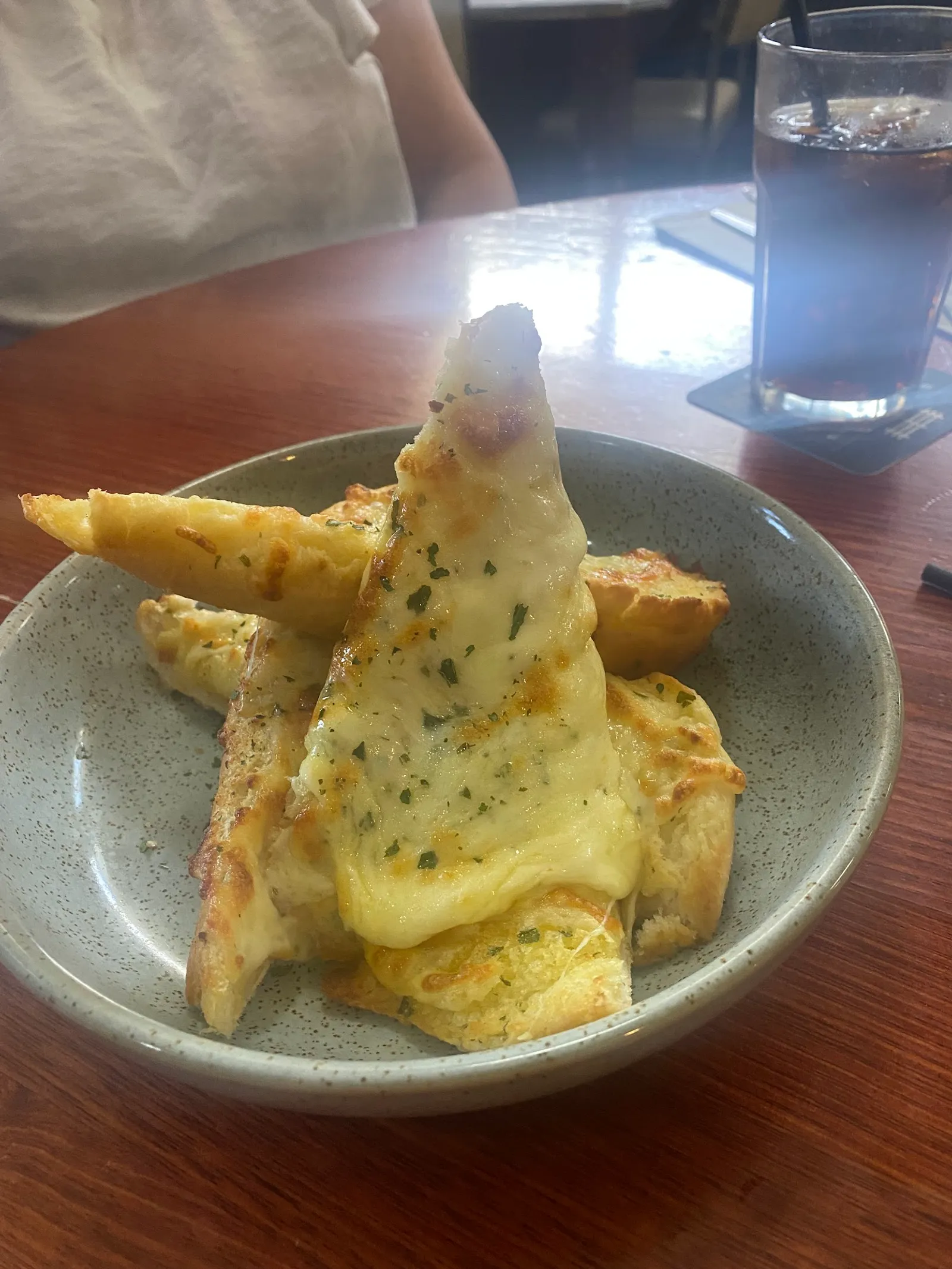 Cheesy garlic bread wedges in a bowl
