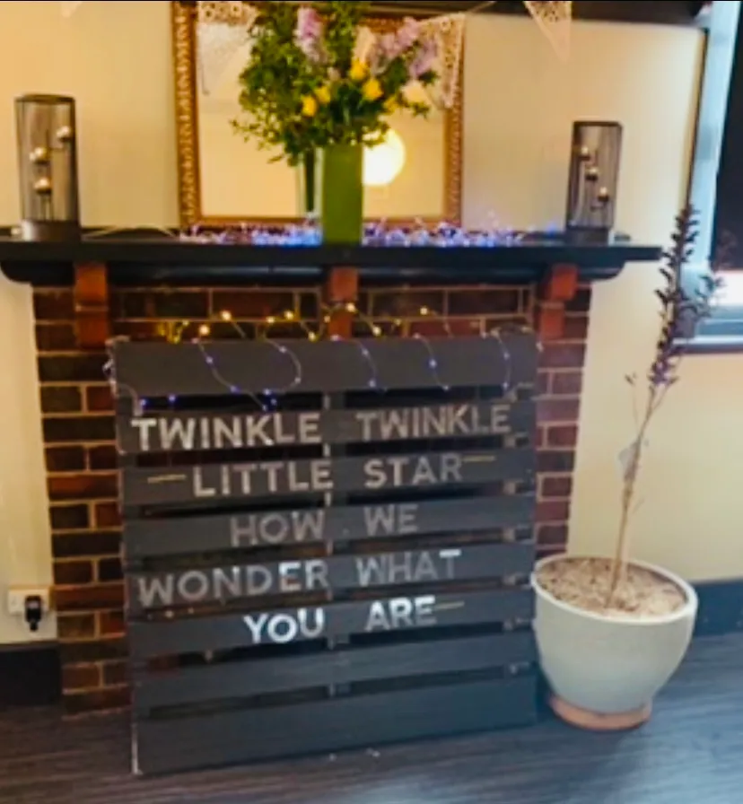 Fireplace mantel decorated for a baby shower celebration
